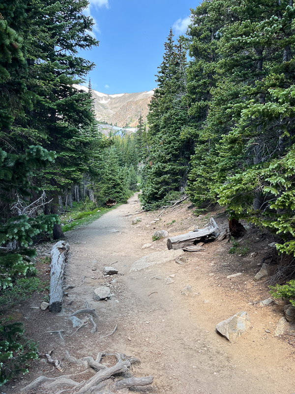 The rocky path leads to the lake